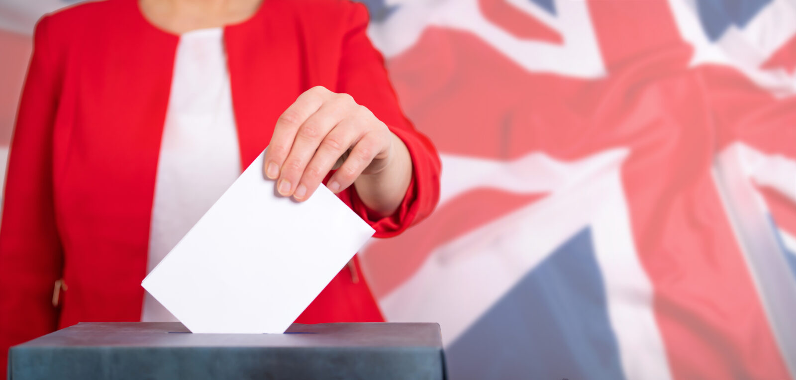 a woman entering her ballot slot to an uk election